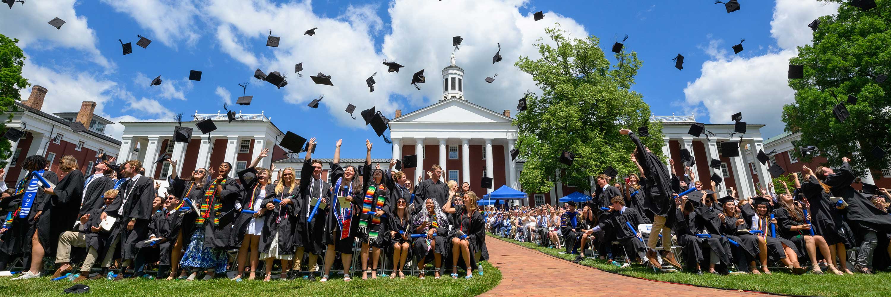 Graduates toss their caps in the air at Commencement